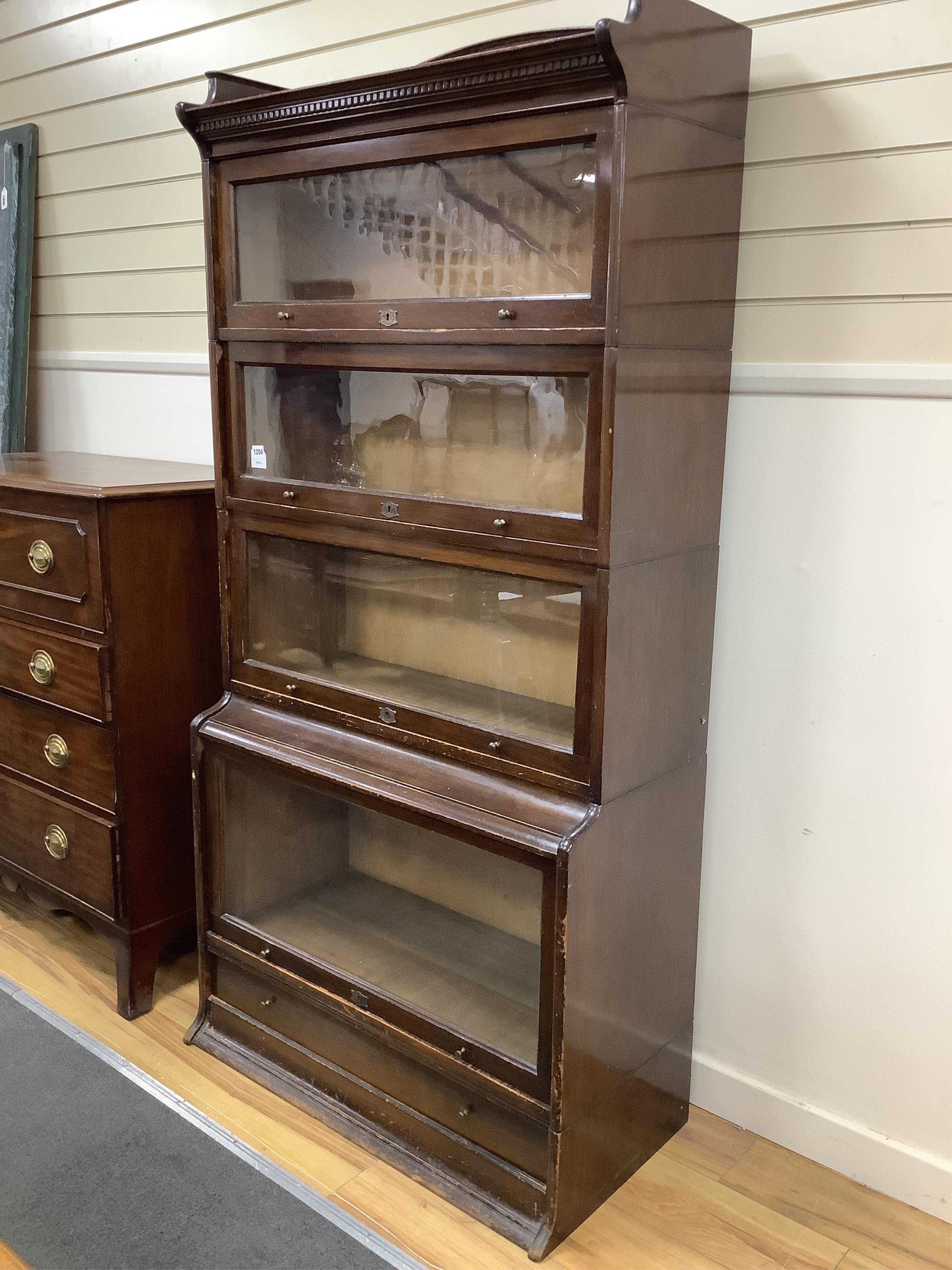 An early 20th century Globe Wernicke style mahogany four section bookcase, width 88cm, depth 36cm, height 180cm. Condition - fair